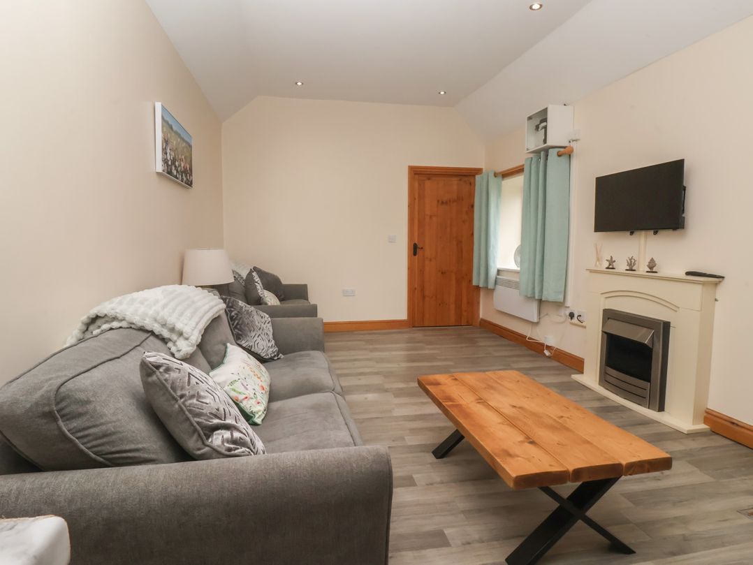 A living room with a sofa and a coffee table at Meadow View Tunstall near Withernsea