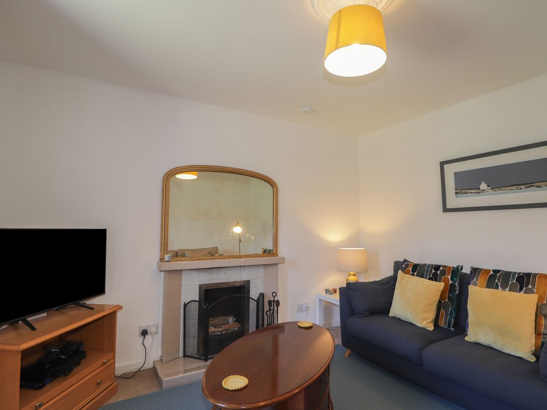 A living room with a sofa and television at Tigh a Phailean in Letterfearn
