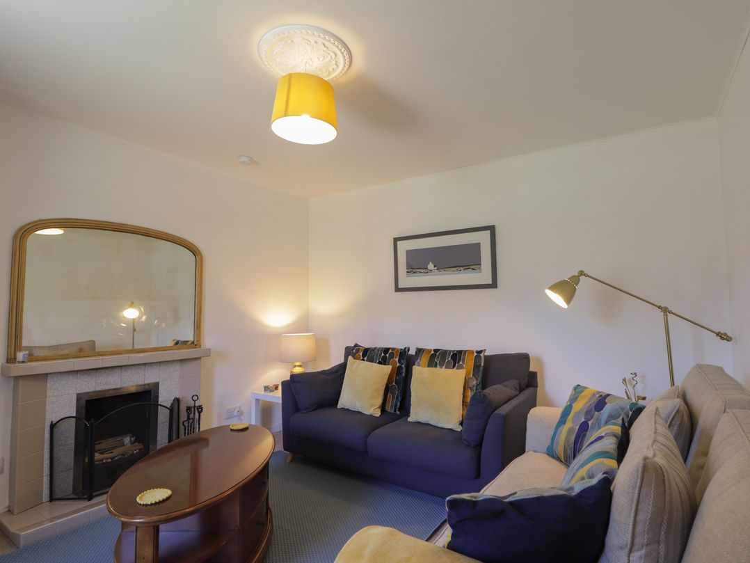 A living room with a sofa and armchair at Tigh a Phailean in Letterfearn