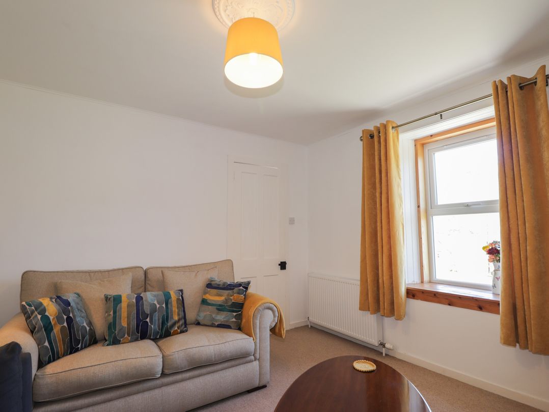 A living room with a sofa and window at Tigh a Phailean in Letterfearn