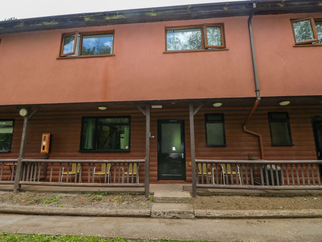 A building exterior with door and windows at Cabin No. 12 - Salt and Fern Cabins Goytre near Port Talbot