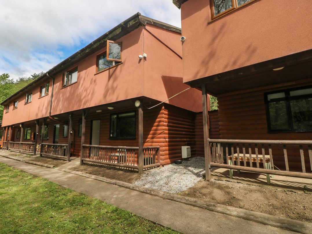 Two cabins with balconies and a pathway at Cabin No. 12 - Salt and Fern Cabins in Goytre near Port Talbot