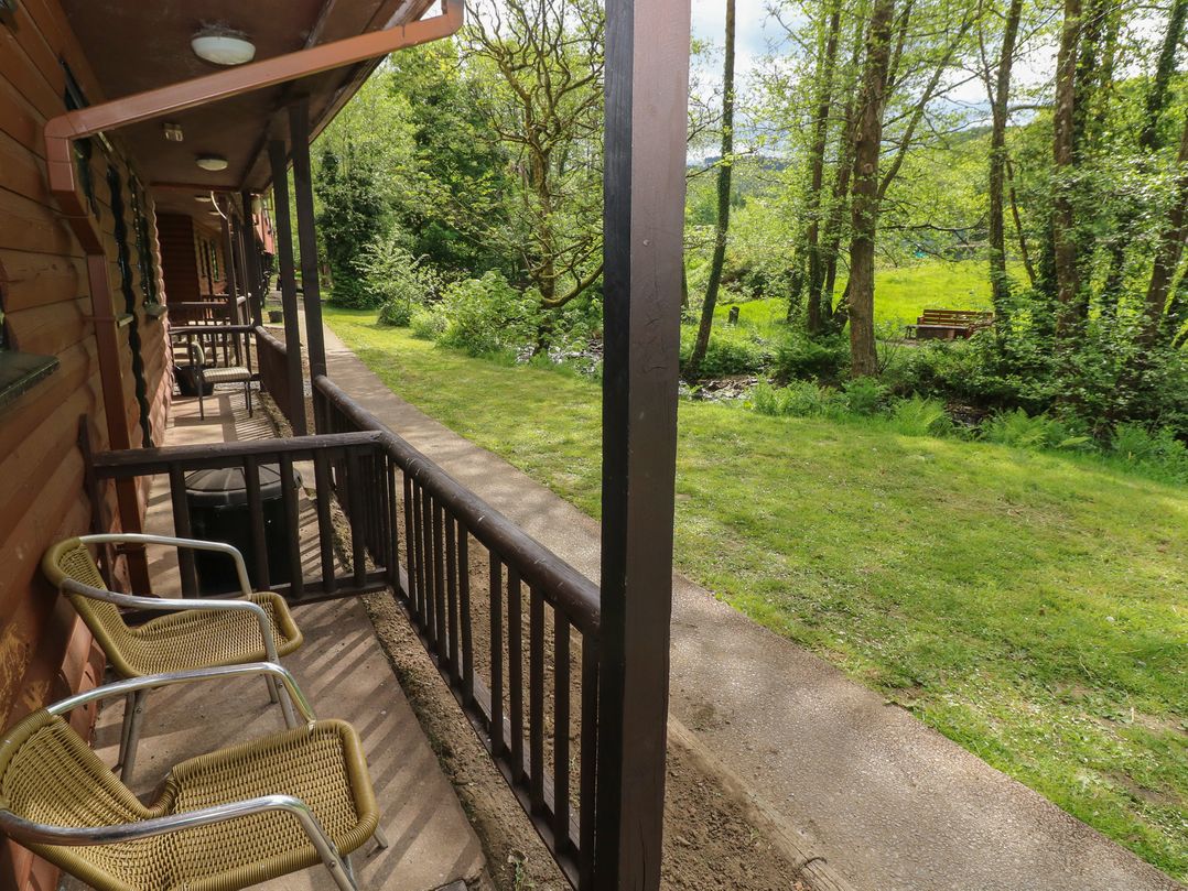 A pathway with chairs and grass at Cabin No. 12 - Salt and Fern Cabins in Goytre near Port Talbot