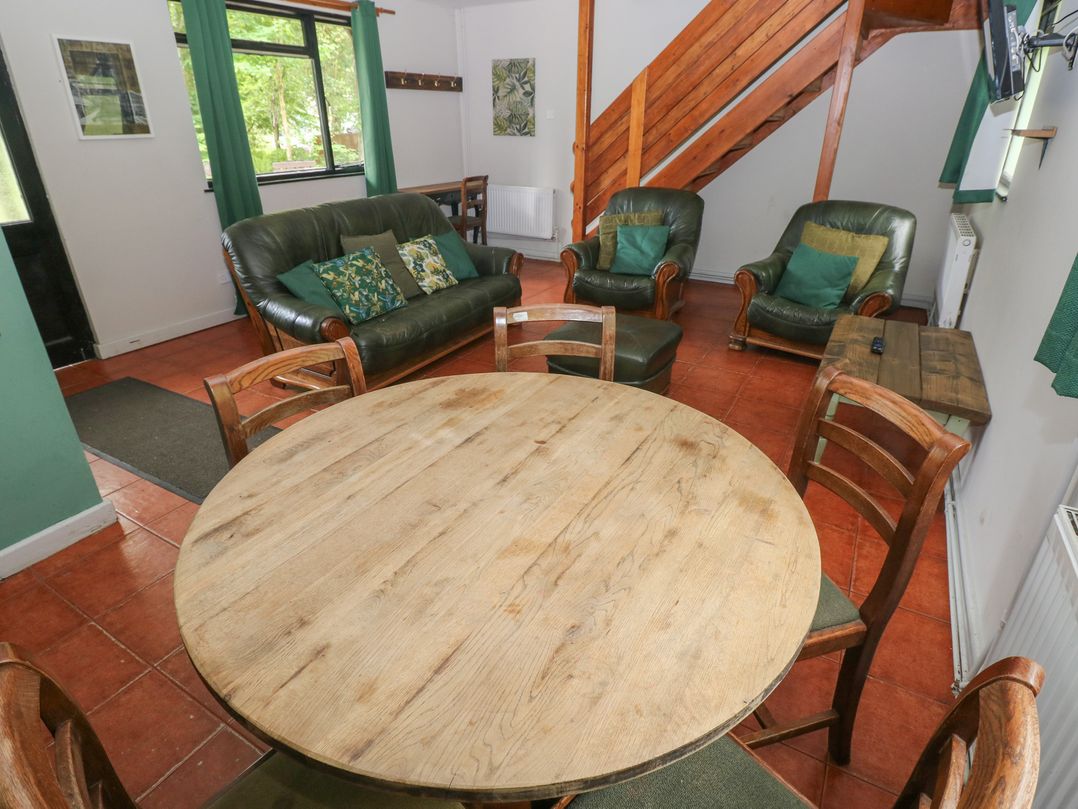 A living room with a table and chairs at Cabin No. 12 - Salt and Fern Cabins in Goytre near Port Talbot