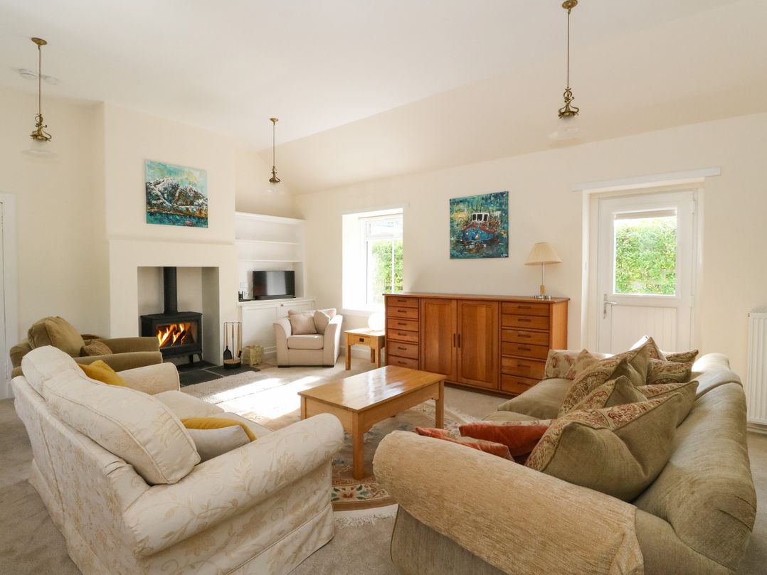 A living room with a sofa and armchair at West House in Stanley