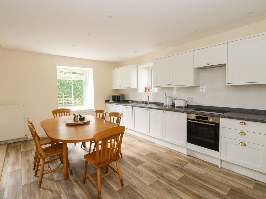A kitchen with a table and chairs at West House in Stanley