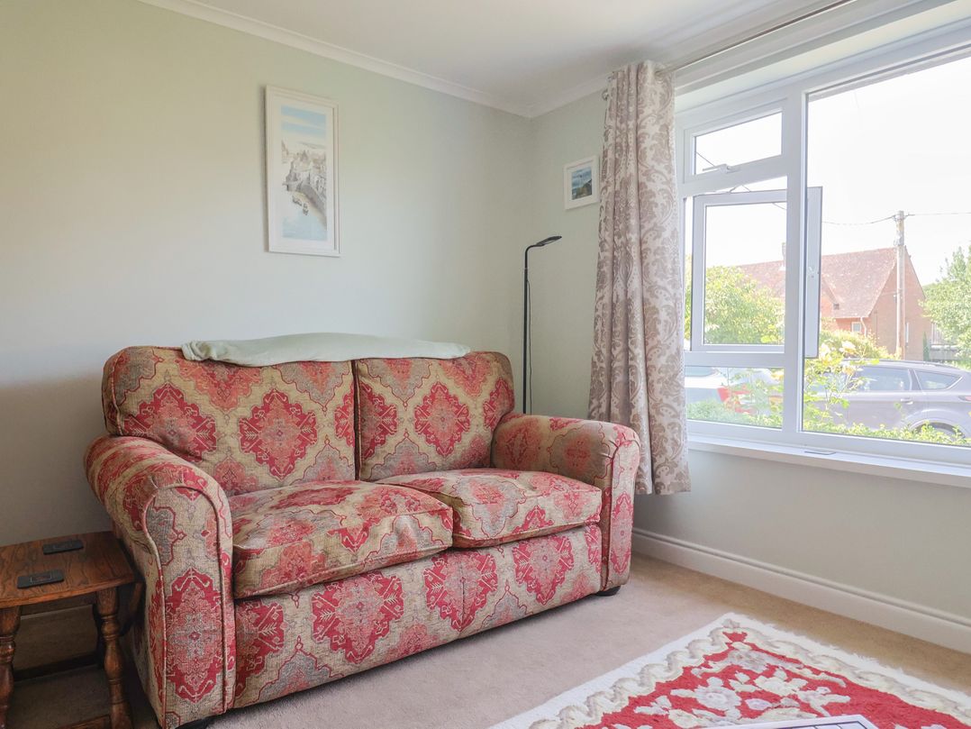 A living room with a sofa and a window at Tane in Winterborne Stickland