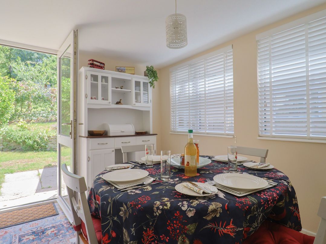 A dining room with a table set for meals at Tane in Winterborne Stickland