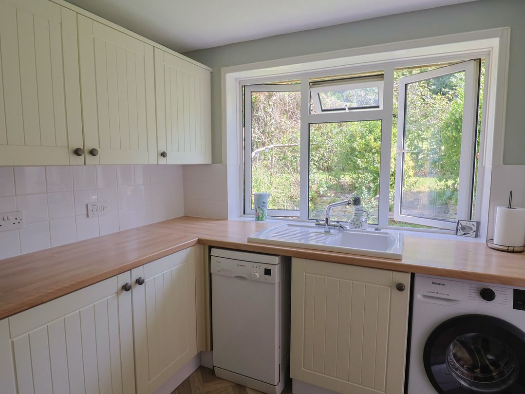 A kitchen with a sink and dishwasher at Tane in Winterborne Stickland