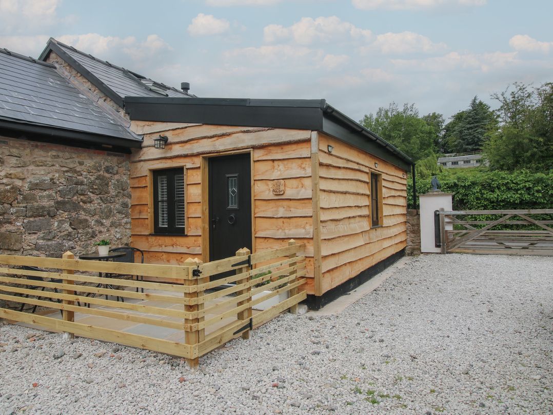 An exterior view of a wooden building at The Dinky Dairy Treflach near Trefonen