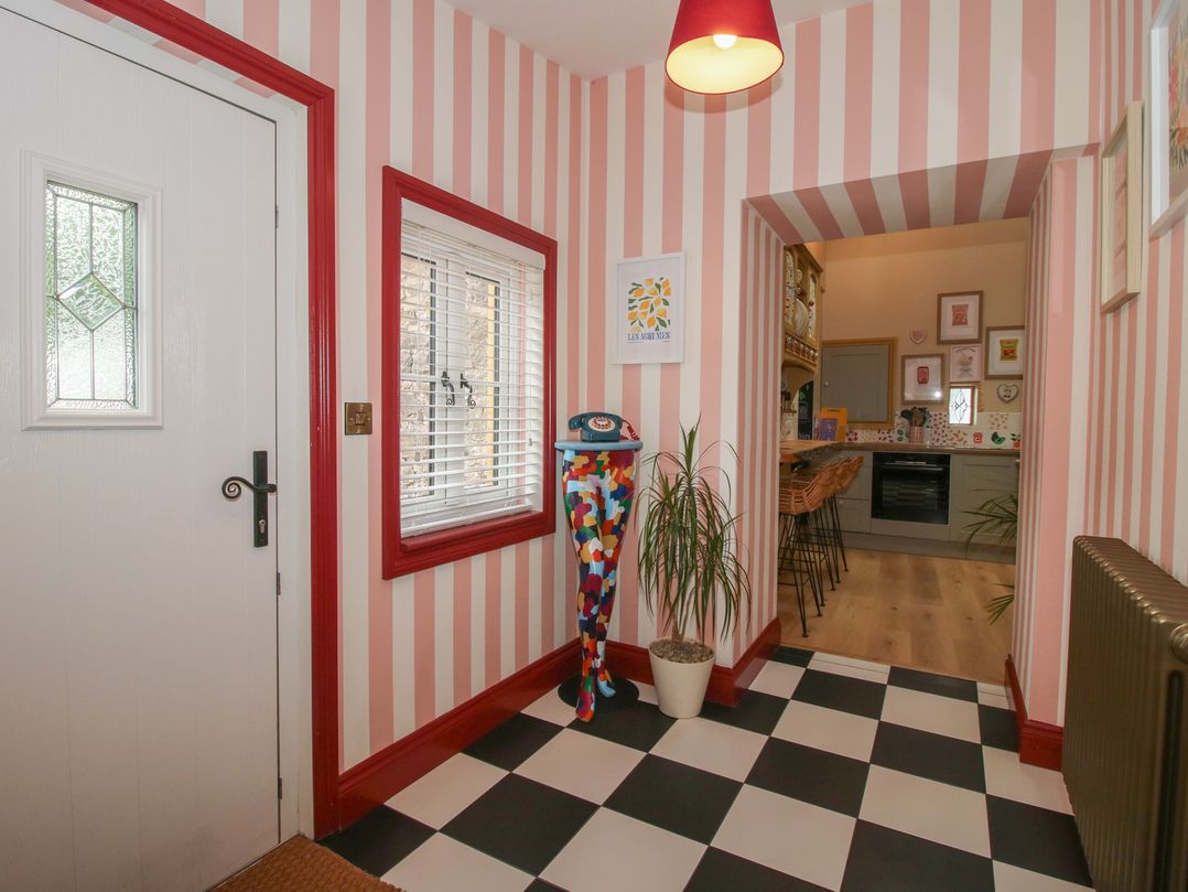A hallway with a window and door at The Dinky Dairy Treflach near Trefonen