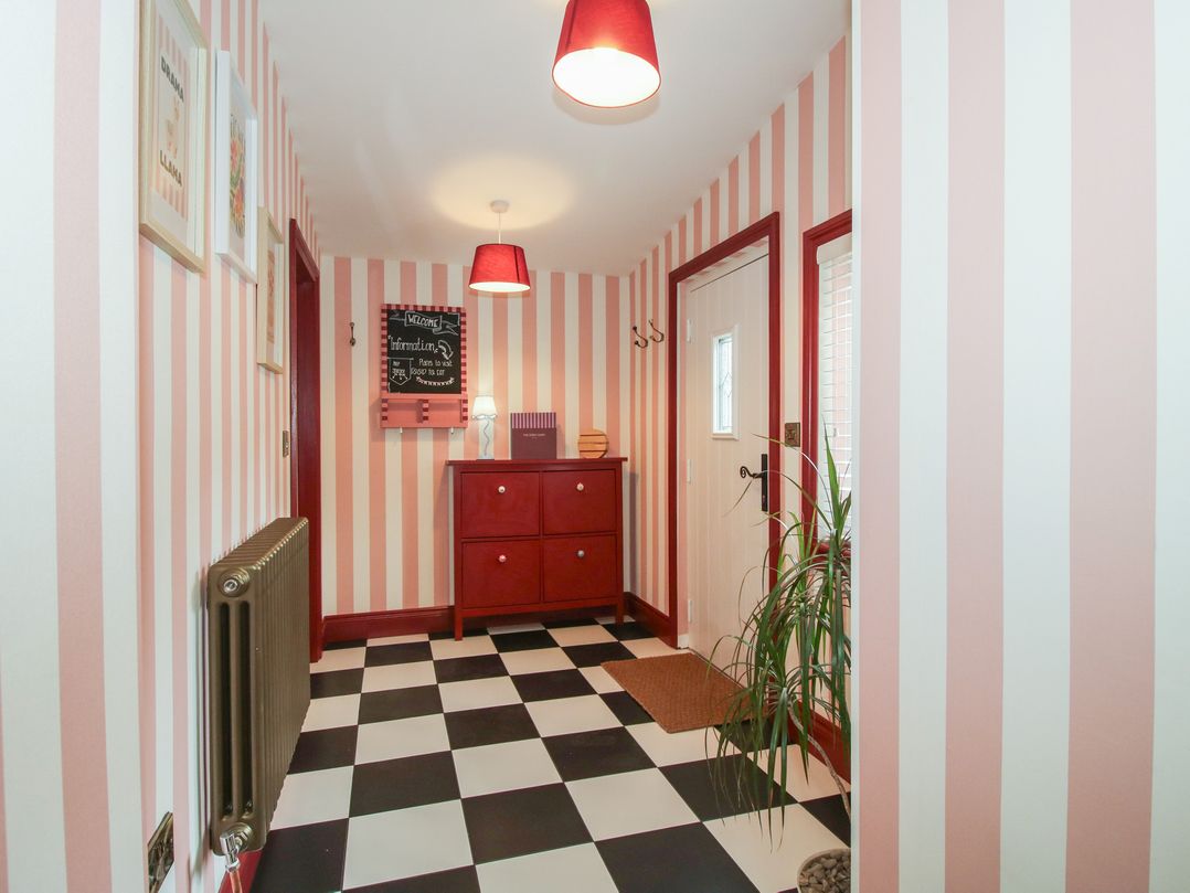A hallway with a drawer unit and chalkboard at The Dinky Dairy in Treflach near Trefonen
