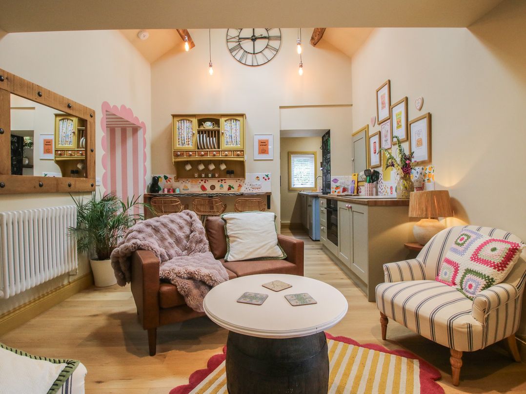 A living room with a sofa and armchair at The Dinky Dairy in Treflach near Trefonen