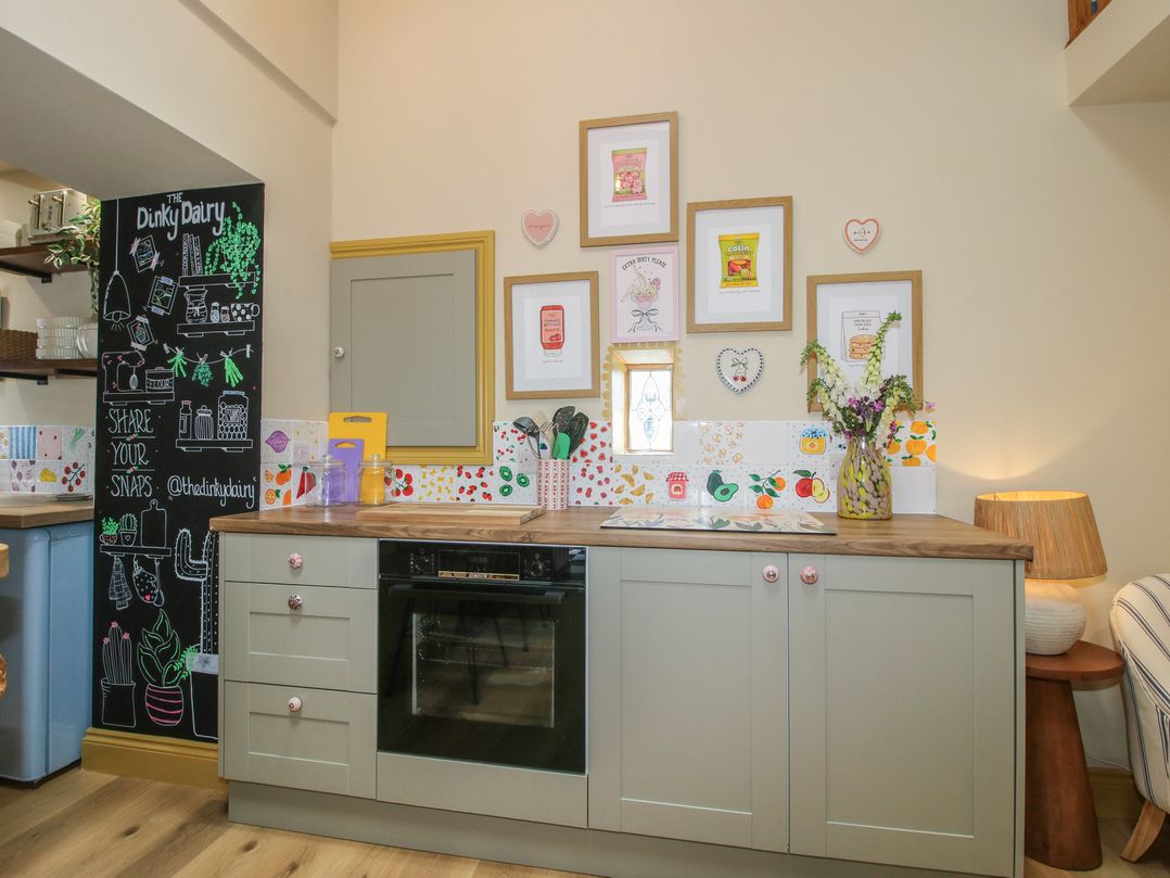 A kitchen with cabinets and wall decorations at The Dinky Dairy Treflach near Trefonen