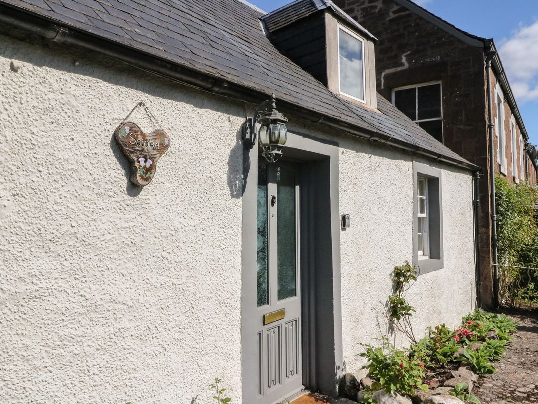 A house entrance with a grey door and window at Sciora Cottage in Crieff