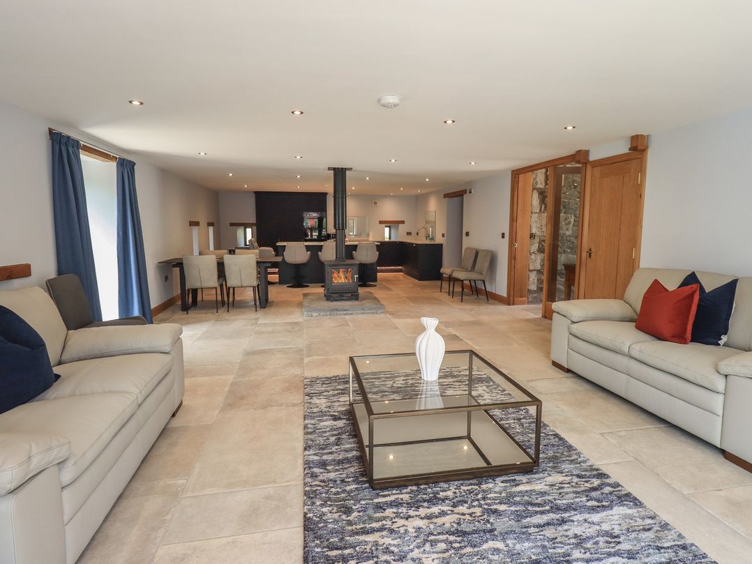 A living room with a coffee table and seating area at Dam House Barn Austwick
