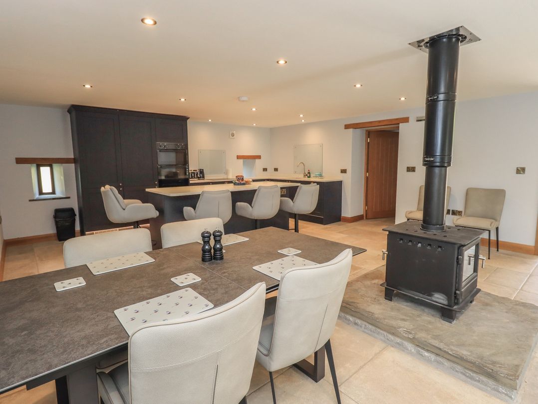 A kitchen with a table and chairs at Dam House Barn Austwick