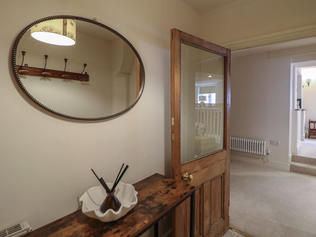 A hallway with a mirror and console table at Lion House in Ashbourne