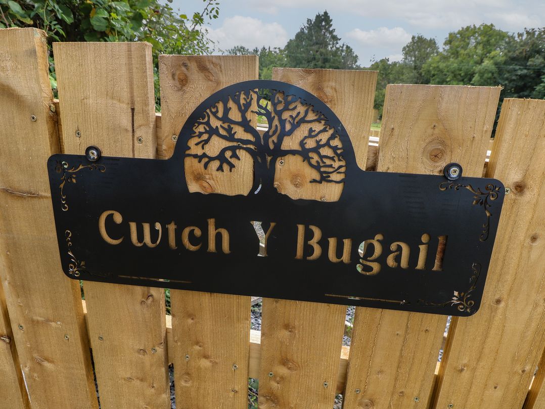 A sign on a wooden fence at Cwtch Y Bugail Near Llandeilo