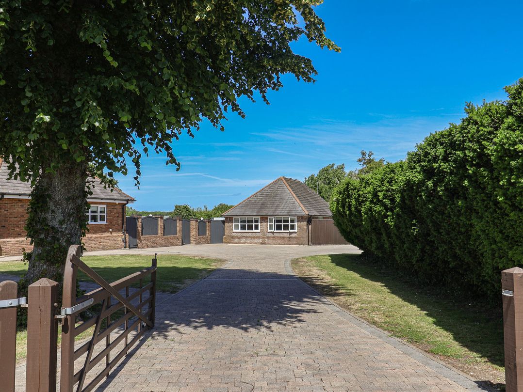 An outdoor view of a building with a driveway at Frome View in Wool