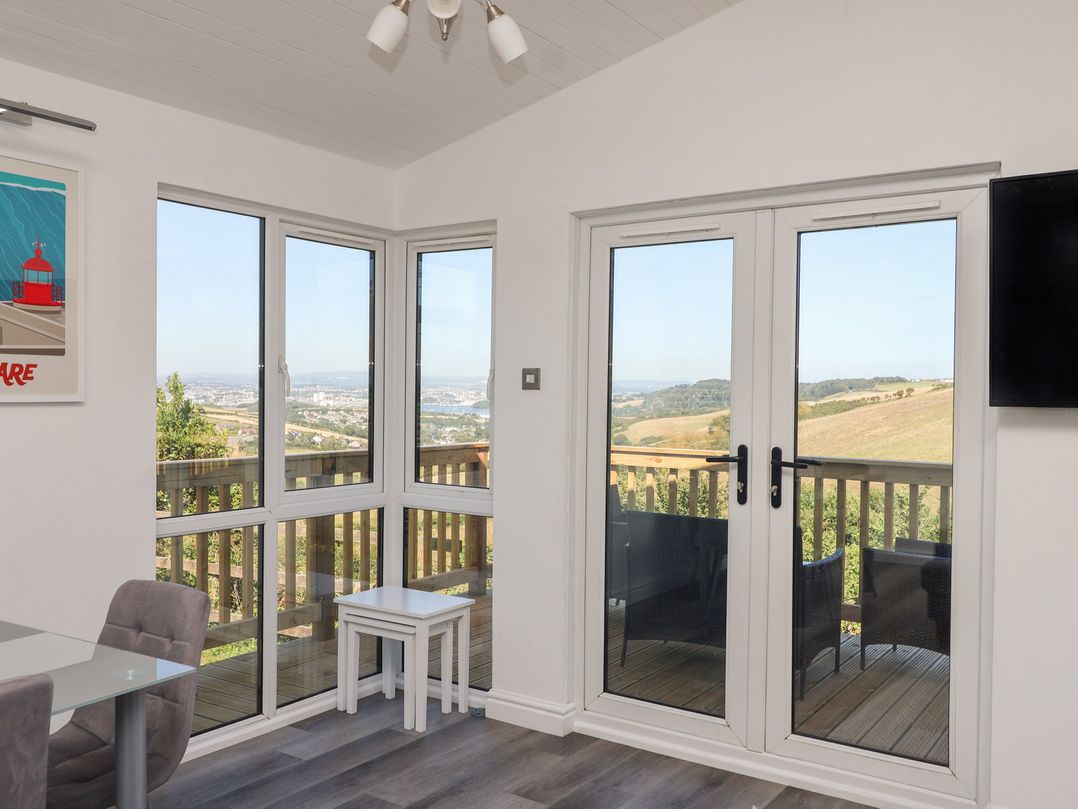 A sunroom with windows and a door at Lodge 19 in Millbrook