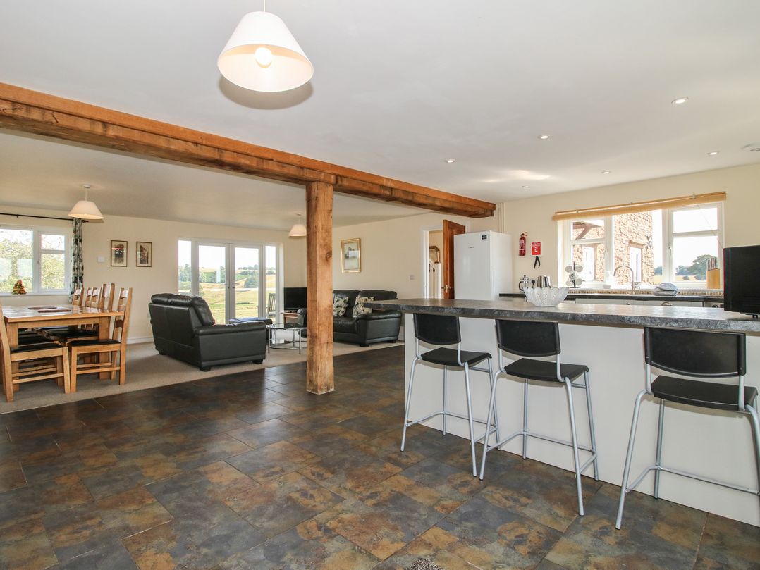 A kitchen with dining area and seating at Wood Cottage in Tenbury Wells