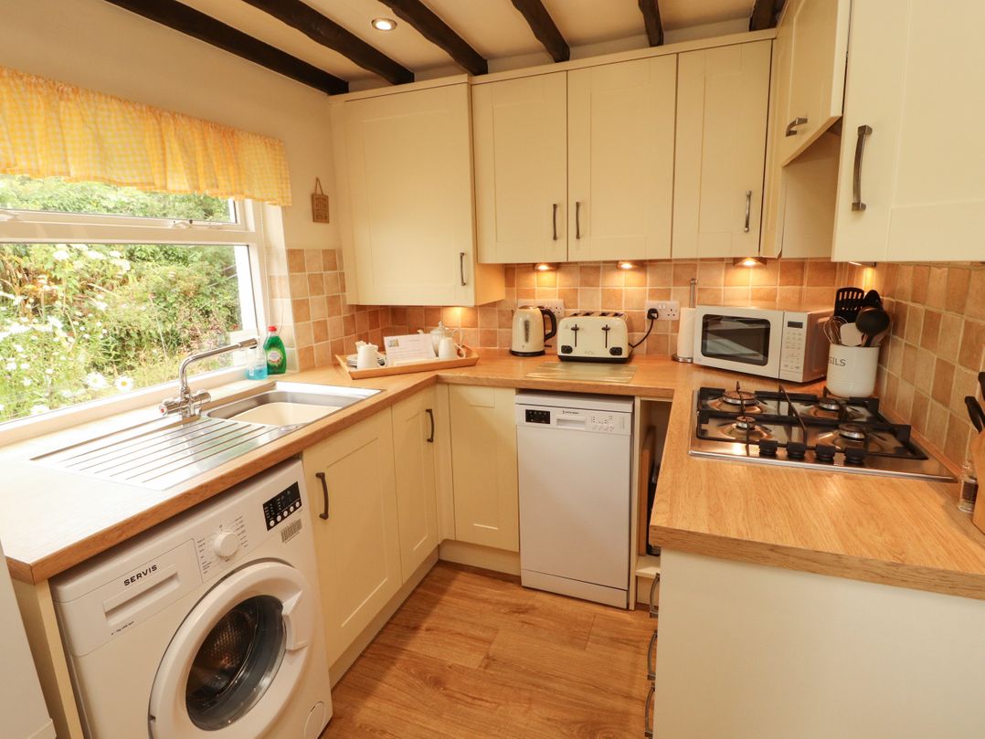 A kitchen with appliances and a window at The Orchard in Levens