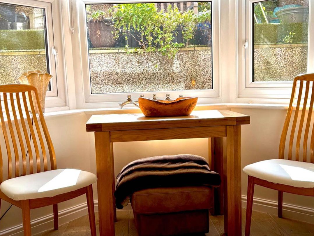 A table with a bowl and chairs at 5 Guests  2 Bedrooms  Free Parking 1min Beach Llandudno