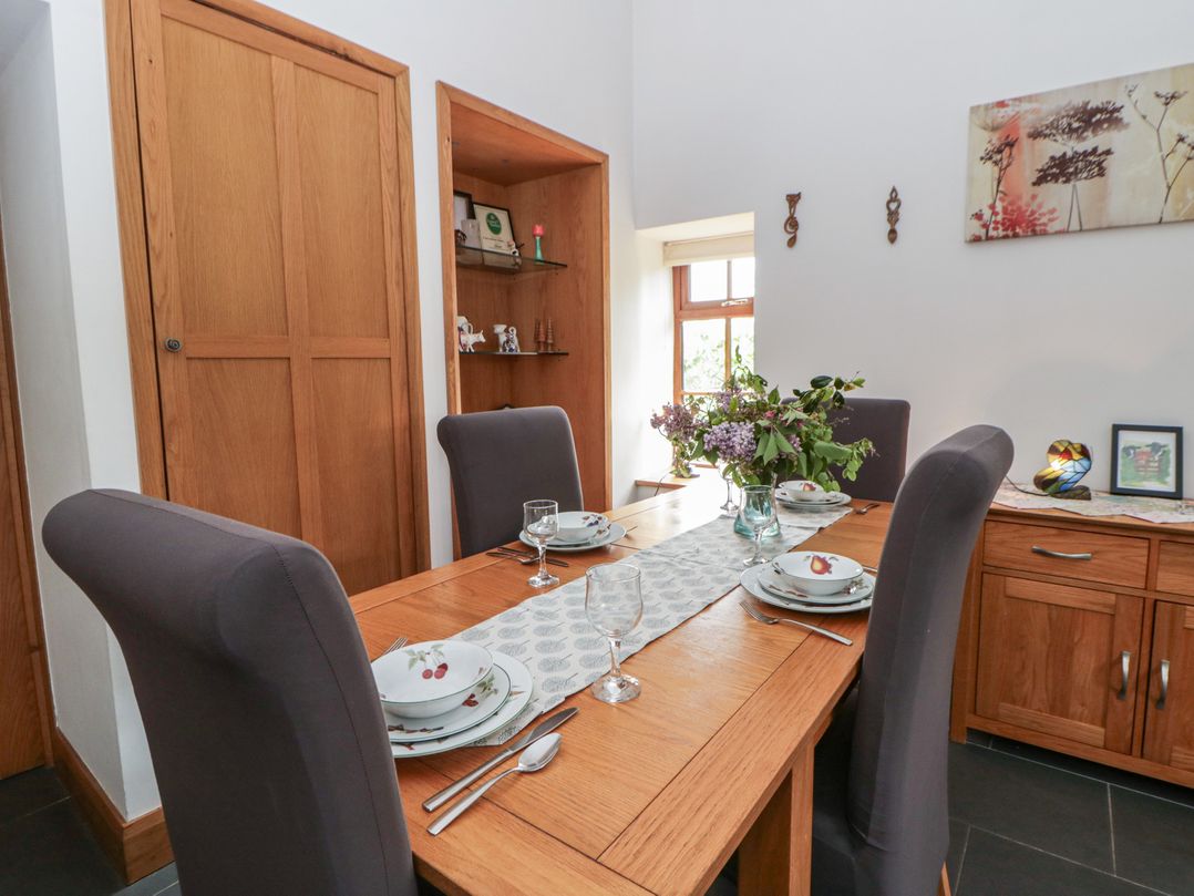 A dining room with a table set for a meal at Yr Hen Llaethdy near Blaen-Cil-Llech near Newcastle Emlyn