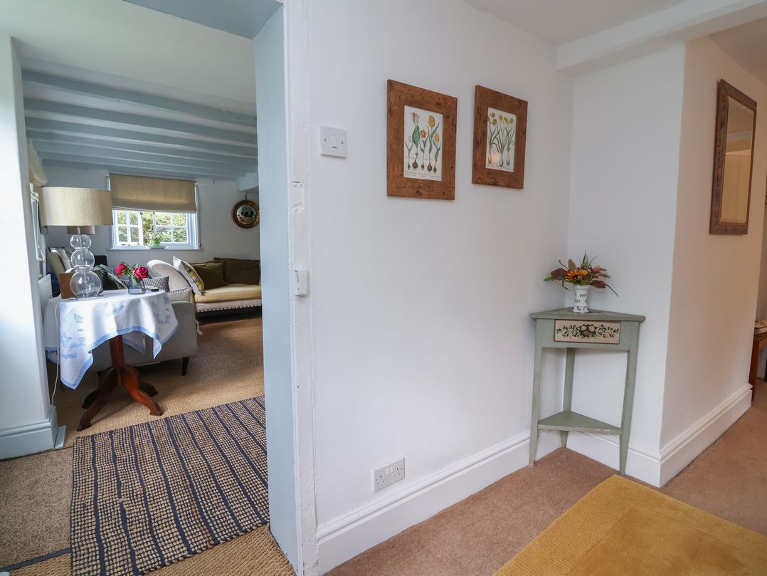 A hallway with a view into a living room at Wolvesacre Mill Cottage in Agden near Whitchurch