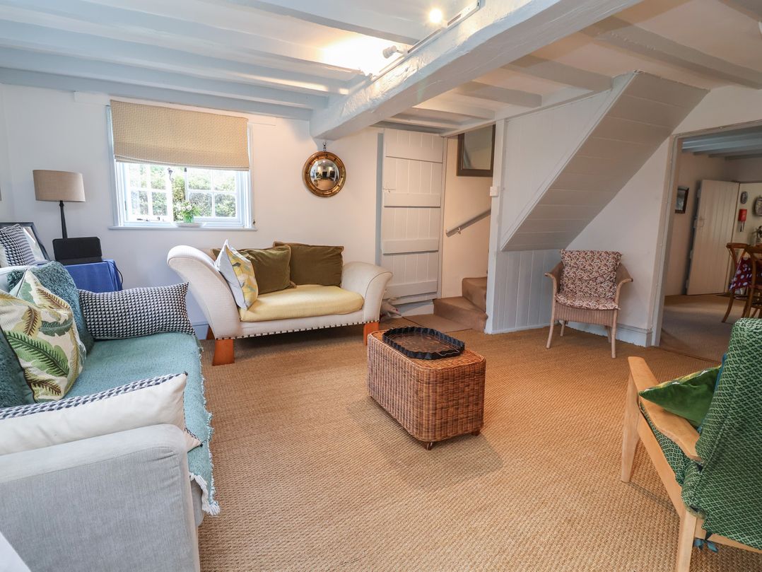 A living room with a sofa and coffee table at Wolvesacre Mill Cottage Agden near Whitchurch