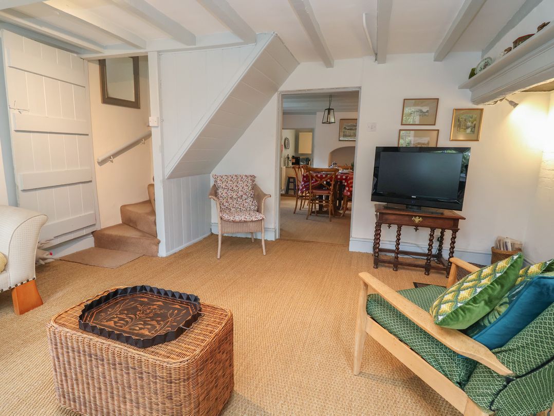 A living room with a television and sofa at Wolvesacre Mill Cottage in Agden near Whitchurch
