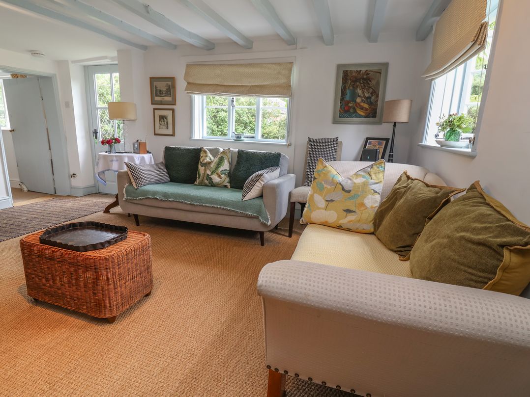 A living room with sofas and a coffee table at Wolvesacre Mill Cottage Agden near Whitchurch