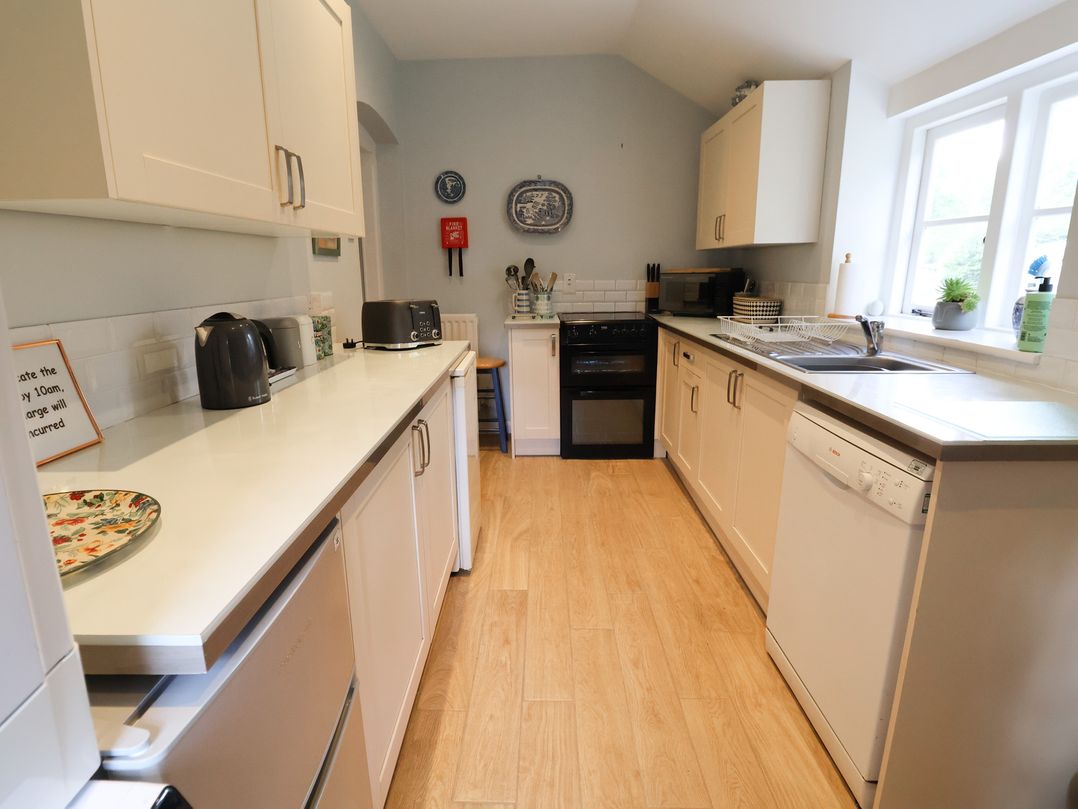 A kitchen with appliances and fixtures at Wolvesacre Mill Cottage Agden near Whitchurch
