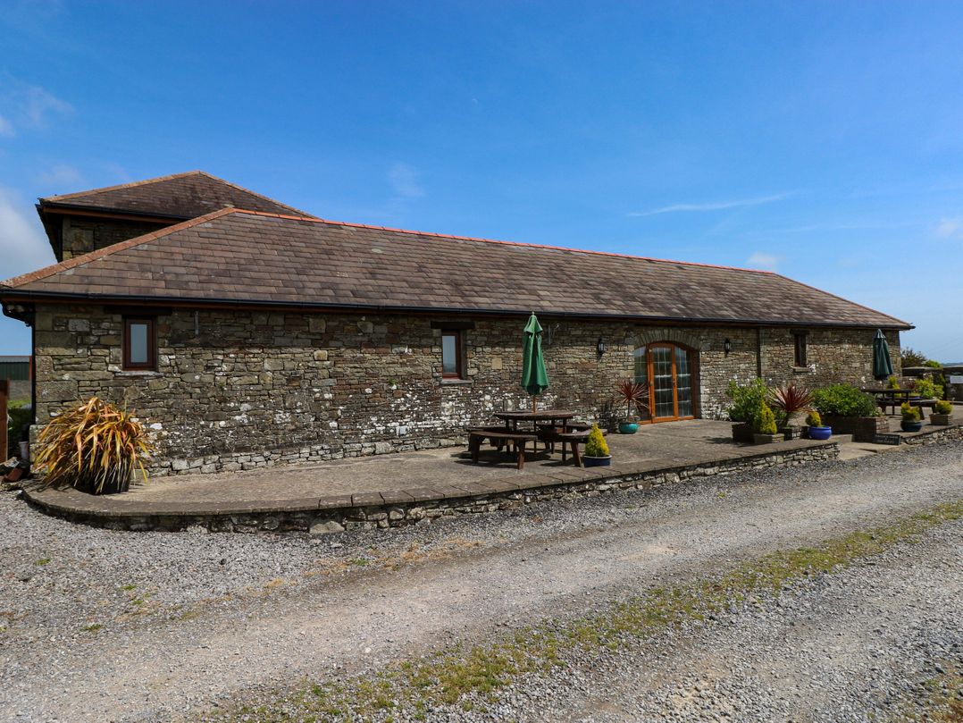 A patio area with furniture at The Dairy in Penuel near Llanmorlais