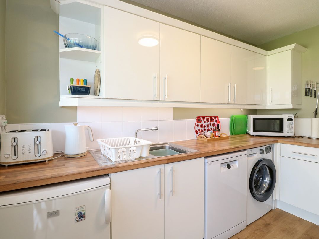 A kitchen with appliances including a microwave and toaster at Steam Cottage in Aviemore