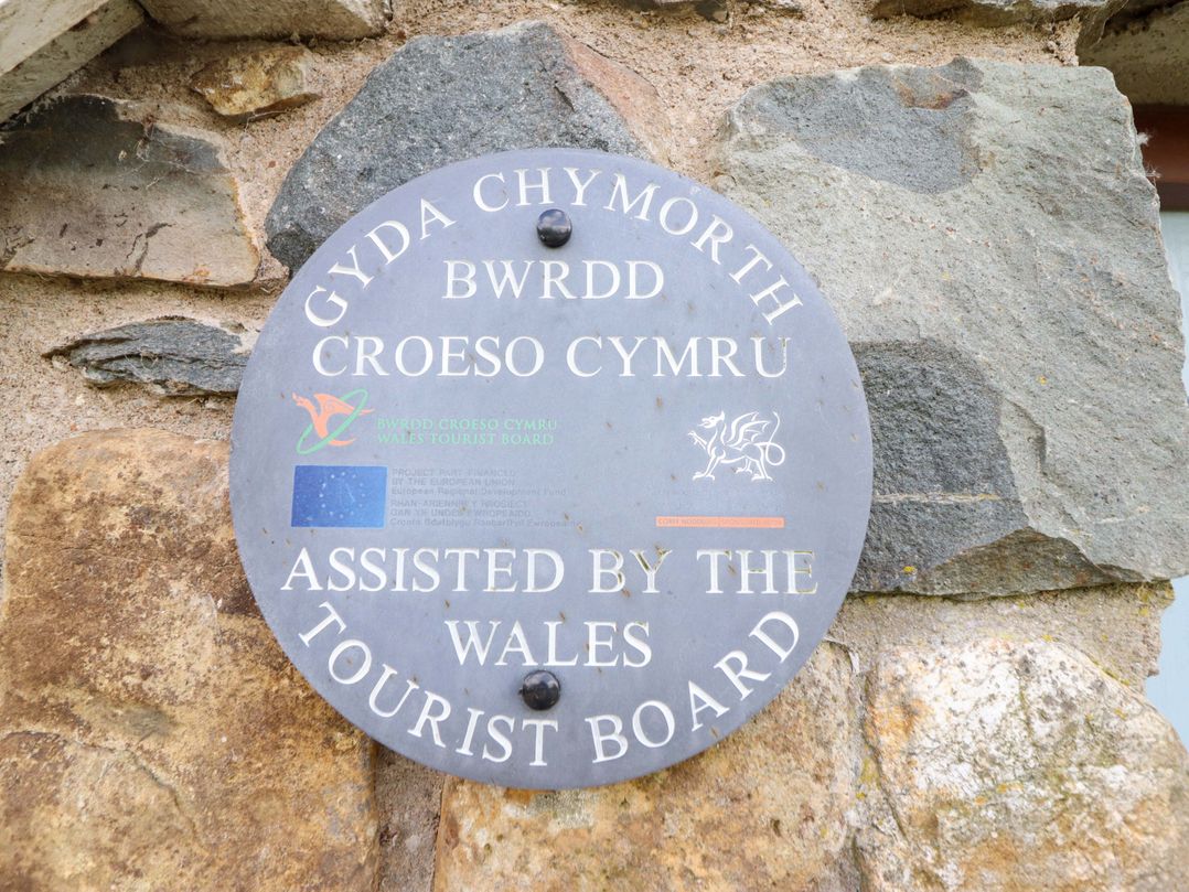 A plaque on a stone wall assisted by the Wales Tourist Board at Stabal Cottage Dolgellau