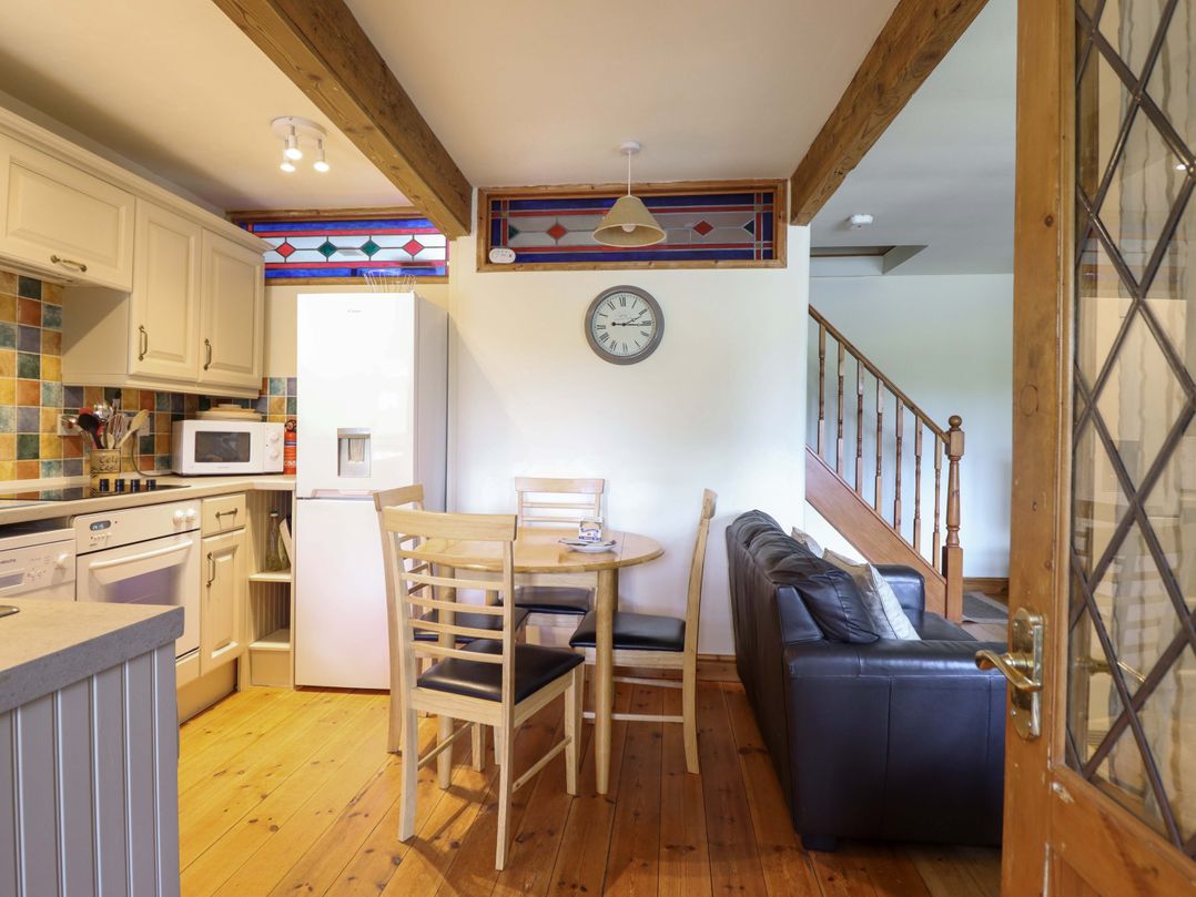A kitchen with a table and chairs at Stabal Cottage in Dolgellau