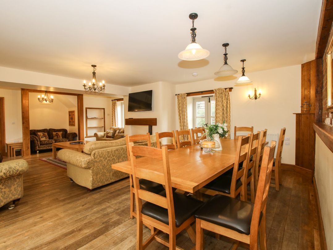 A dining room with a table and chairs at Trooper's Barn in Westhope