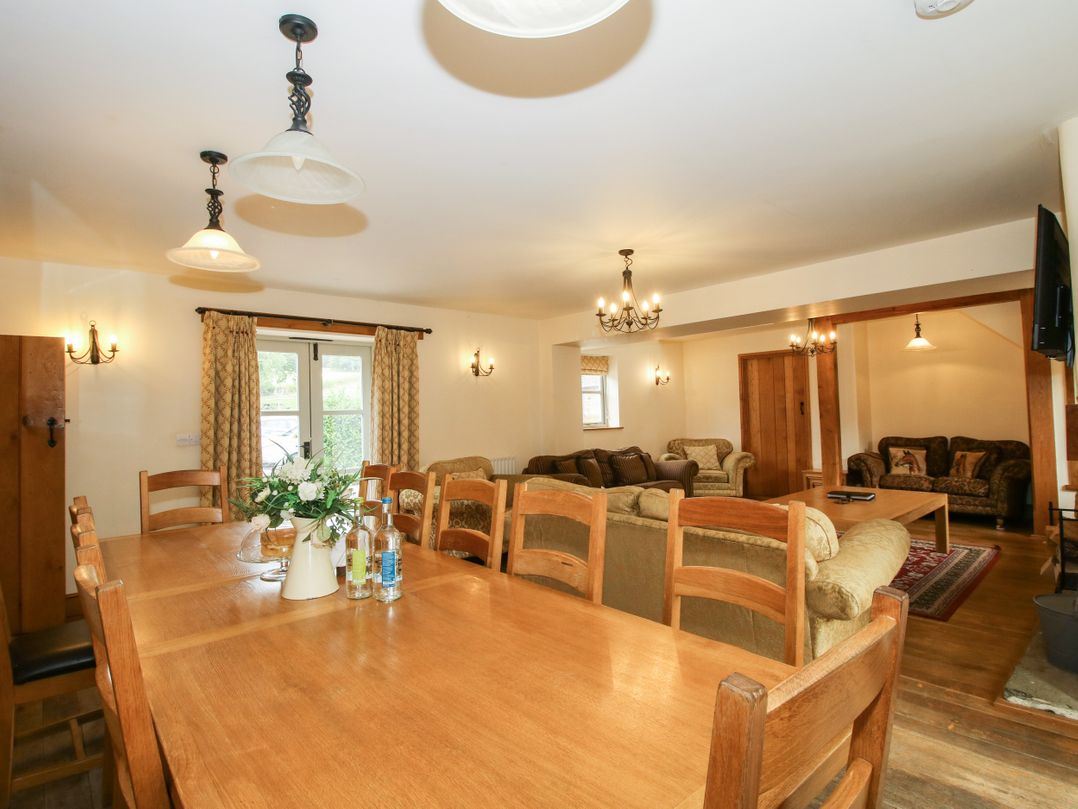 A dining room with a large table and seating at Trooper's Barn in Westhope