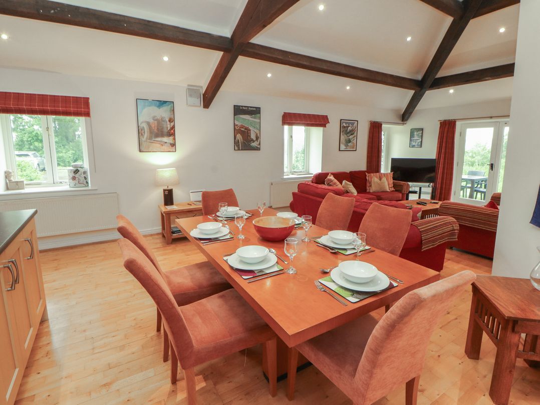 A dining room with a table set for dinner at Winster Fields, Cartmel Fell near Windermere