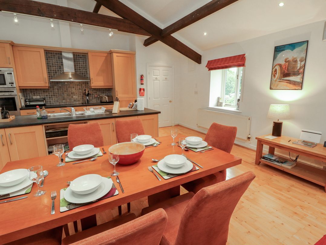 A dining area with a kitchen and dining table at Winster Fields Cartmel Fell near Windermere