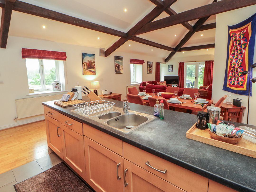 A kitchen with a sink and dining area at Winster Fields Cartmel Fell near Windermere