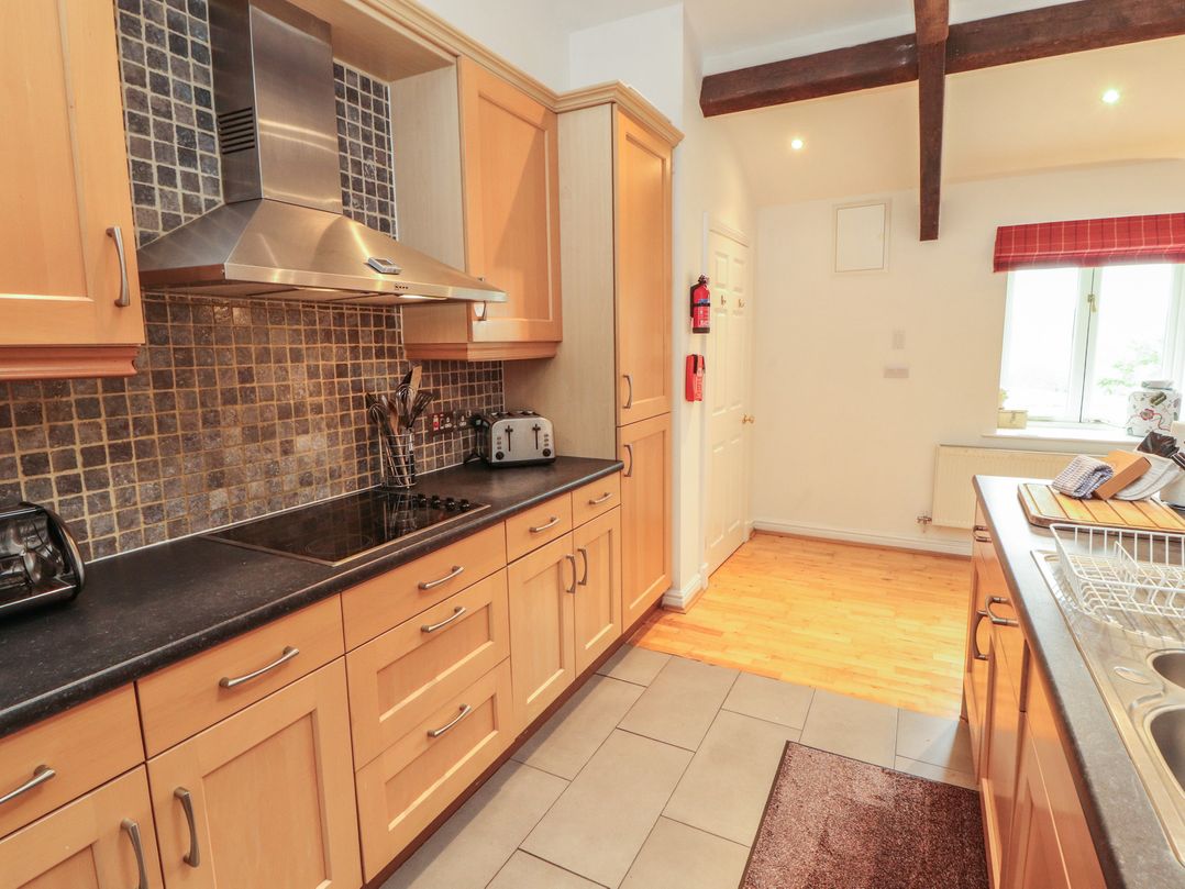 A kitchen with cabinets and appliances at Winster Fields Cartmel Fell near Windermere