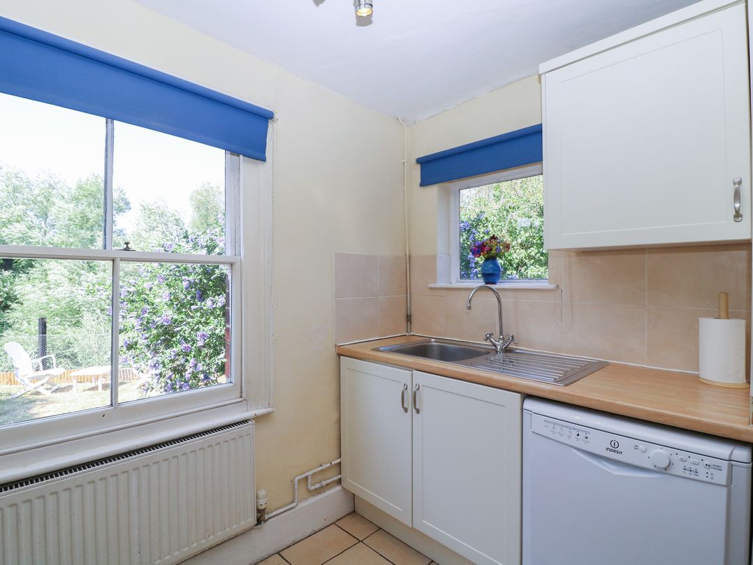 A kitchen with a sink and cabinets at The Lock House in Gloucester