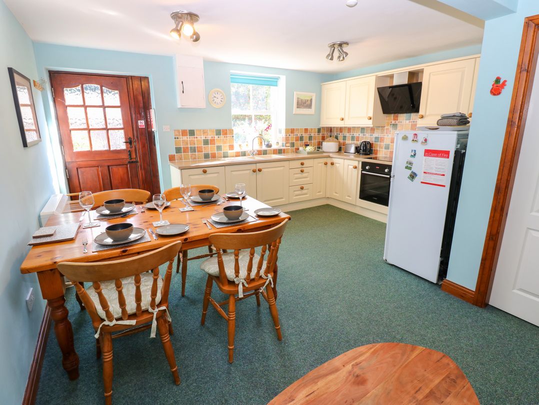 A kitchen with a table and chairs at Barnbrook in Carperby near Leyburn