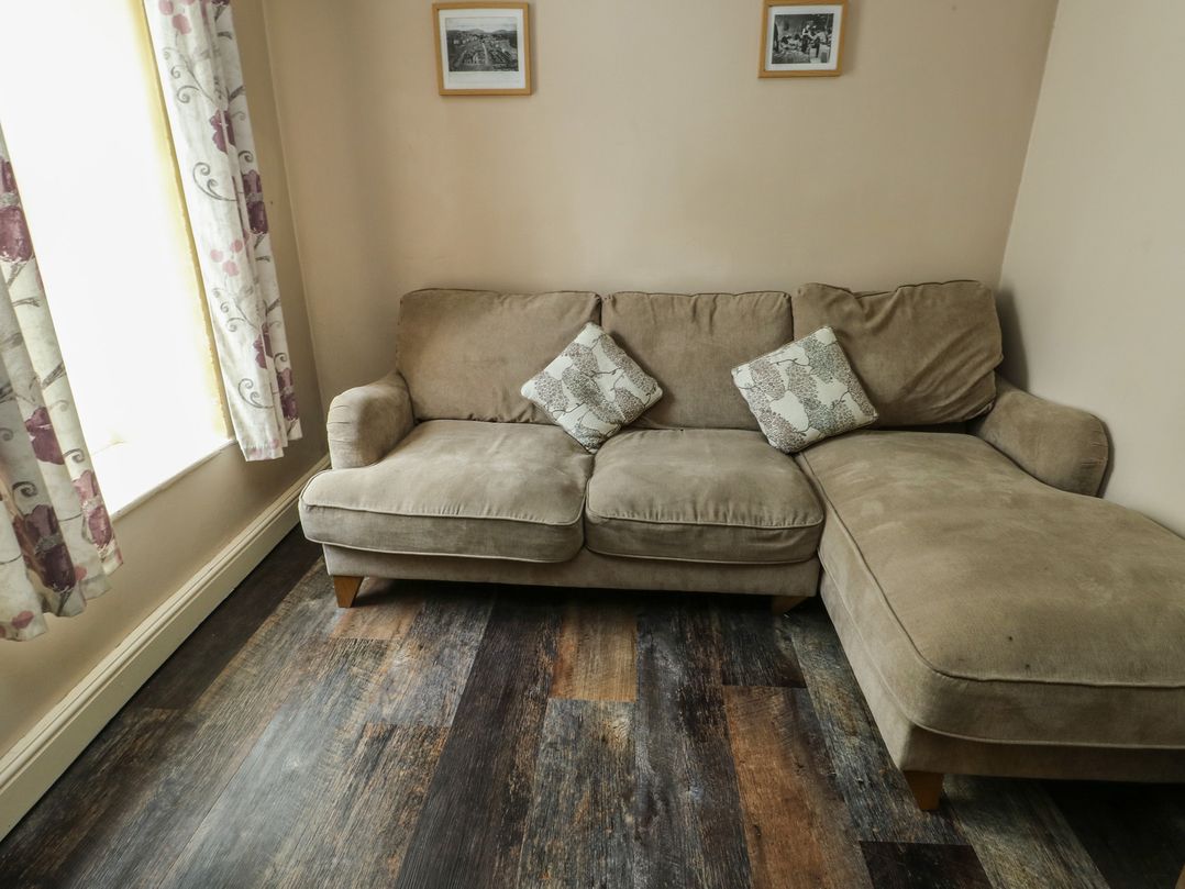A living room with a sofa and cushions at Halford Hill in Llanberis