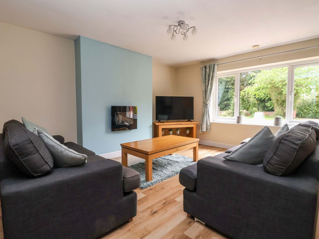 A living room with a sofa and television at The Granary in York
