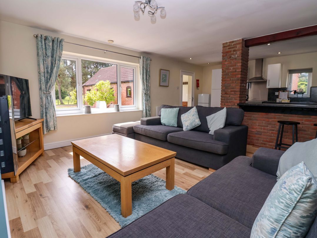 A living room with a sofa and television at The Granary in York