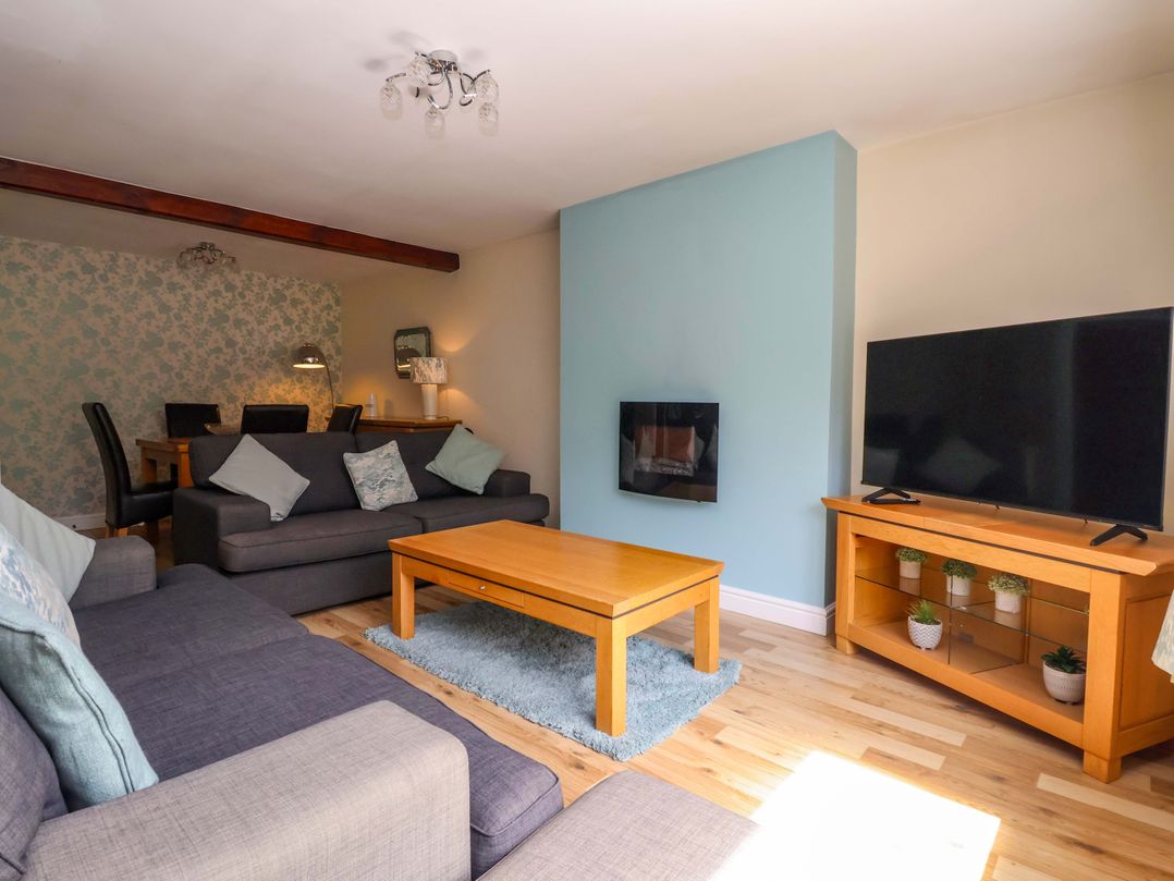 A living room with a sofa and television at The Granary in York
